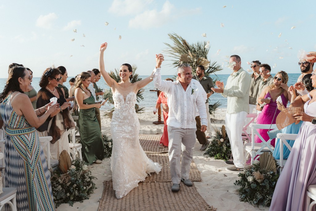 Bride and groom celebrating with family and friends after their destination wedding ceremony in Riviera Maya, Mexico