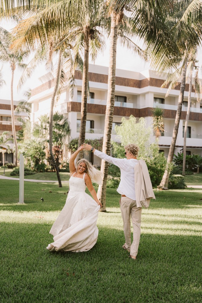 Bride and groom dancing together in the gardens after their destination wedding in Tulum, Mexico.