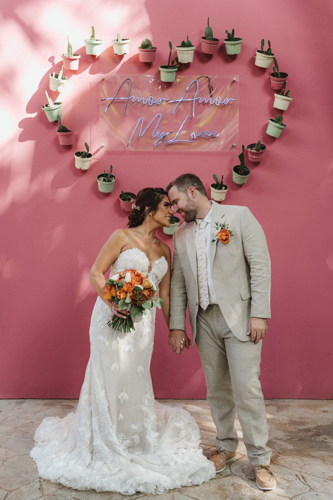 Bride and groom smiling together after their wedding ceremony in Playa del Carmen, Mexico.